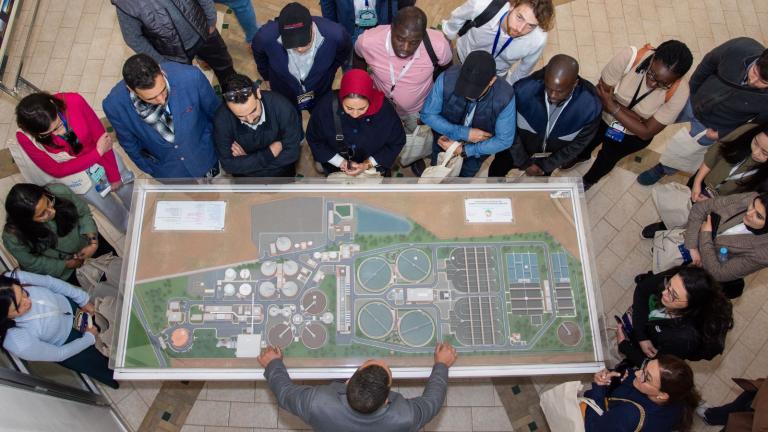 an aerial view of a group looking at a model of a city